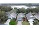 Aerial view of houses near a lake, highlighting curb appeal at 25001 Cranes Roost Cir, Leesburg, FL 34748