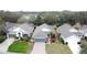 Aerial view of a house and neighborhood near a lake at 25001 Cranes Roost Cir, Leesburg, FL 34748
