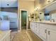 Large bathroom with double vanity, walk-in shower, and linen closet at 25001 Cranes Roost Cir, Leesburg, FL 34748