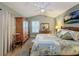Bright bedroom with a queen-size bed, wooden dresser, and large closet at 25001 Cranes Roost Cir, Leesburg, FL 34748