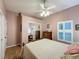 Bright bedroom with mirrored closet doors and wood flooring at 25001 Cranes Roost Cir, Leesburg, FL 34748