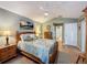 Cozy bedroom with a queen-size bed, dresser, and wood flooring at 25001 Cranes Roost Cir, Leesburg, FL 34748