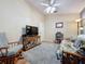 Cozy common area with a futon, rocking chair, and TV at 25001 Cranes Roost Cir, Leesburg, FL 34748