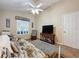 Comfortable common area with a futon, rocking chair, and TV at 25001 Cranes Roost Cir, Leesburg, FL 34748