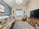 Relaxing common area with a futon, rocking chair, and large window at 25001 Cranes Roost Cir, Leesburg, FL 34748