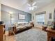 Spacious common area with a futon, rocking chair, and TV at 25001 Cranes Roost Cir, Leesburg, FL 34748
