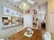 Charming kitchen nook with a rustic wooden table and stained glass window at 25001 Cranes Roost Cir, Leesburg, FL 34748