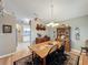 Bright dining area with a wooden table and chairs, and view into kitchen at 25001 Cranes Roost Cir, Leesburg, FL 34748