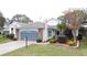 House exterior showcasing a well-maintained lawn and brick facade at 25001 Cranes Roost Cir, Leesburg, FL 34748