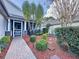 Landscaped front yard with brick walkway and lush greenery at 25001 Cranes Roost Cir, Leesburg, FL 34748