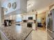 Spacious kitchen with white cabinets, granite countertops, and stainless steel appliances at 25001 Cranes Roost Cir, Leesburg, FL 34748