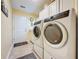 Laundry room with washer, dryer, and cabinets at 25001 Cranes Roost Cir, Leesburg, FL 34748