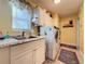 Bright laundry room with washer, dryer, and a utility sink at 25001 Cranes Roost Cir, Leesburg, FL 34748