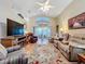 Relaxing living room with hardwood floors, comfortable seating, and a fireplace at 25001 Cranes Roost Cir, Leesburg, FL 34748