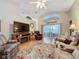 Comfortable living room with hardwood floors, fireplace, and plenty of seating at 25001 Cranes Roost Cir, Leesburg, FL 34748