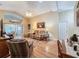 Living room with hardwood floors, comfortable seating, and access to a sunroom at 25001 Cranes Roost Cir, Leesburg, FL 34748