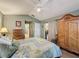 Main bedroom with king-size bed, ample closet space, and a view of the backyard at 25001 Cranes Roost Cir, Leesburg, FL 34748