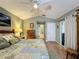 Main bedroom with a king-size bed, dresser, and access to a private bathroom at 25001 Cranes Roost Cir, Leesburg, FL 34748