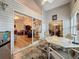 Bright sunroom features a table with chairs, and views of the living room and backyard at 25001 Cranes Roost Cir, Leesburg, FL 34748