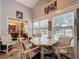 Sunroom with table and chairs, offering views into the dining room and backyard at 25001 Cranes Roost Cir, Leesburg, FL 34748
