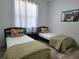 Twin bedroom with green bedding and plenty of natural light at 259 Grand Rapids Dr, Poinciana, FL 34759