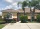 Single-story home with attractive landscaping and a paved driveway at 259 Grand Rapids Dr, Poinciana, FL 34759