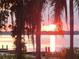 Stunning sunset view over a tranquil lake at 259 Grand Rapids Dr, Poinciana, FL 34759