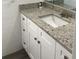 Bathroom with granite countertop, white cabinets, and a single sink at 5241 Magnolia Ter, Fruitland Park, FL 34731