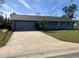 Newly renovated home with a driveway and lawn at 5241 Magnolia Ter, Fruitland Park, FL 34731