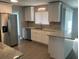Modern kitchen with white cabinets and granite countertops at 5241 Magnolia Ter, Fruitland Park, FL 34731
