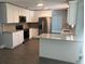 Modern kitchen featuring white cabinets, granite counters, and stainless steel appliances at 5241 Magnolia Ter, Fruitland Park, FL 34731