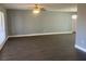 Bright living room with dark gray vinyl flooring and neutral walls at 5241 Magnolia Ter, Fruitland Park, FL 34731