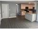Open living room with kitchen views and wood-look floors at 5241 Magnolia Ter, Fruitland Park, FL 34731