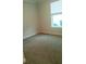 Bedroom with carpeted floor and a window with blinds at 573 Lago Matisse St, Kissimmee, FL 34759