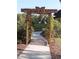 Entrance to a butterfly garden with arbor and walkway at 573 Lago Matisse St, Kissimmee, FL 34759