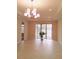 Spacious dining room with sliding glass doors and chandelier at 573 Lago Matisse St, Kissimmee, FL 34759