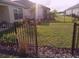 Landscaped front yard with fenced perimeter at 573 Lago Matisse St, Kissimmee, FL 34759