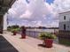 Tranquil lakefront patio with potted plants and a view at 573 Lago Matisse St, Kissimmee, FL 34759