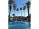 Relaxing resort-style pool with a pergola and lounge chairs at 573 Lago Matisse St, Kissimmee, FL 34759