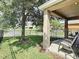 Covered patio with chairs and a view of fenced backyard at 1030 Bending Oak Trl, Winter Garden, FL 34787