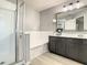 Bathroom with walk-in shower, soaking tub, and dark vanity at 1030 Bending Oak Trl, Winter Garden, FL 34787