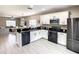 Modern kitchen with stainless steel appliances and granite countertops at 1030 Bending Oak Trl, Winter Garden, FL 34787