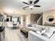 Spacious living room with a sectional sofa and large TV at 1030 Bending Oak Trl, Winter Garden, FL 34787