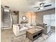 Living room with sectional sofa, coffee table, and stairs at 1030 Bending Oak Trl, Winter Garden, FL 34787