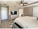 Large main bedroom with dresser, TV, and en-suite bathroom at 1030 Bending Oak Trl, Winter Garden, FL 34787