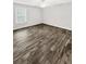 Spacious bedroom with wood-look tile floors and window at 105 Northlake Dr # 105, Sanford, FL 32773