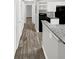 Hallway with wood-look tile floors and access to rooms at 105 Northlake Dr # 105, Sanford, FL 32773