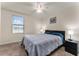 Spacious bedroom with gray bedding and modern nightstands at 1567 Candlefire Row, Kissimmee, FL 34744