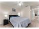 Cozy bedroom with gray bedding and access to the hallway at 1567 Candlefire Row, Kissimmee, FL 34744