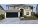 Two-story house with a two-car garage and landscaped yard at 2553 Shanti Dr, Kissimmee, FL 34746